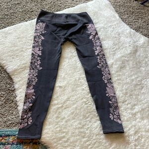 Purple fabletics leggings with light purple butterflies on the legs